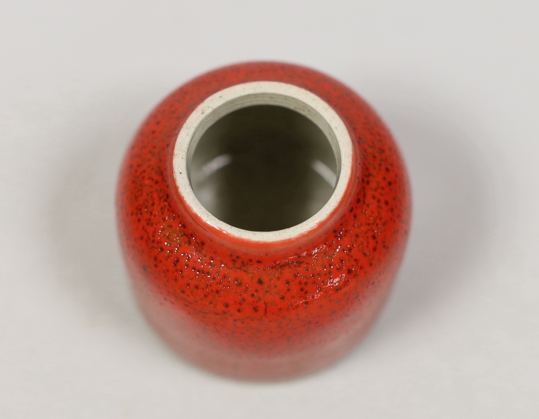 A Chinese red glazed brushwasher. 6cm tall